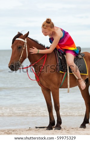 Horse riding on the beach Royalty-Free Stock Photo #59975329