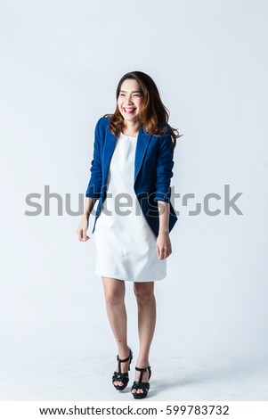 beautiful asian businesswomanwith cute smile isolated on grey background