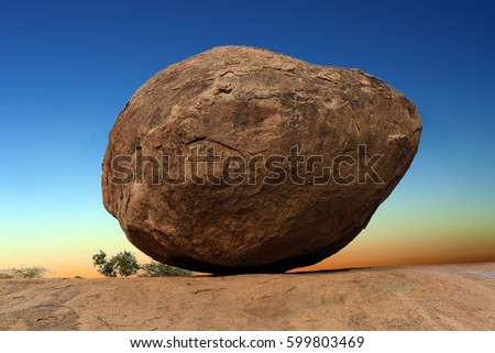Krishna's butterball, the giant natural balancing rock in Mahabalipuram, Tamil Nadu, India Royalty-Free Stock Photo #599803469