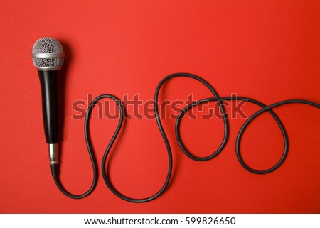 Vocal audio microphone on a bright red background