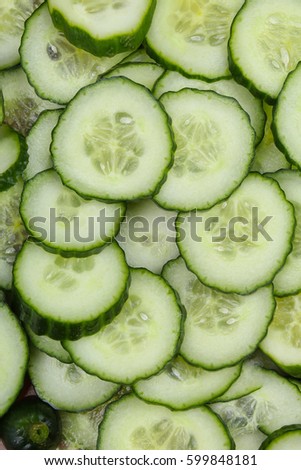Cucumber slices as background. Green fresh cucumbers as background. Cucumber pattern texture. Vegetable food photo.