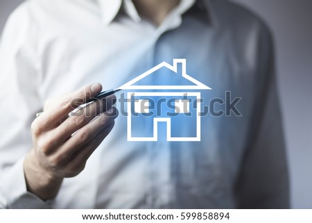 man hand pen with house in screen