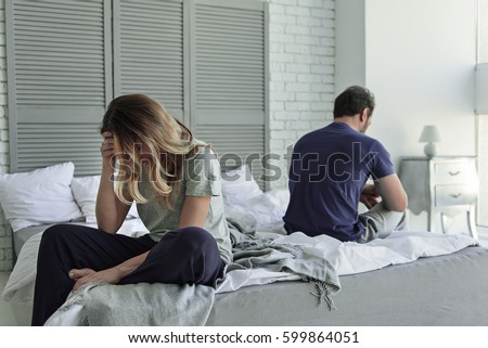 Despaired married couple is on bed Royalty-Free Stock Photo #599864051