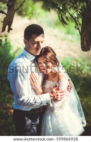 Beautiful bride hugging outdoors