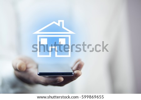 man hand phone with house in screen