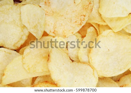 Chips pattern. Yellow salted potato chips as background. Chips texture studio photo.