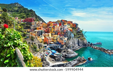 Beautiful view of Manarola town. Is one of five famous colorful villages of Cinque Terre National Park in Italy, suspended between sea and land on sheer cliffs. Liguria region of Italy.  Royalty-Free Stock Photo #599904944