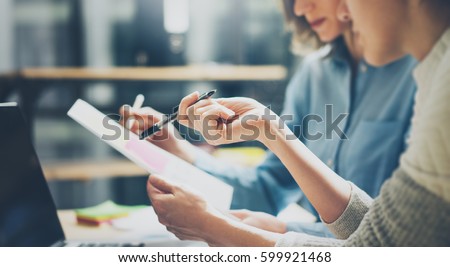 Group of young coworkers working together in modern office.Woman talking with colleague about new startup project.Business people brainstorming concept.Selective focus.Horizontal,blurred Royalty-Free Stock Photo #599921468