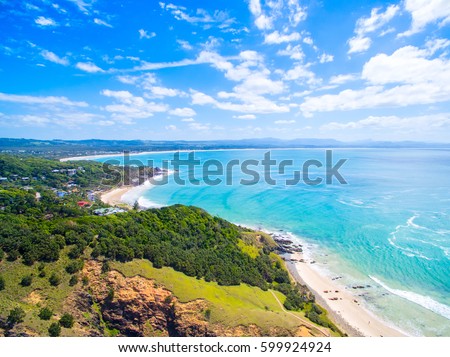 An aerial view of the Byron Bay coastline on Australia's east coast. Byron Bay is a popular tourist destination for travelers from all over the world.  Royalty-Free Stock Photo #599924924
