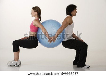 Couple working out with exercise ball