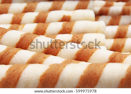 Ice cream curl wafer sticks as background. Wafer biscuit swirled curls stick texture. Wafers pattern.