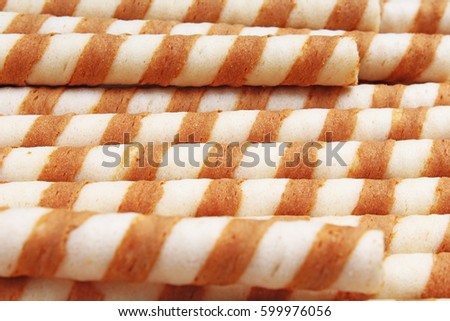 Ice cream curl wafer sticks as background. Wafer biscuit swirled curls stick texture. Wafers pattern.