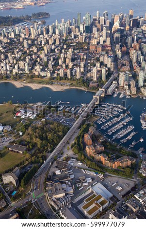 Aerial city view of Downtown Vancouver, Burrard Bridge, and False Creek. Picture taken in British Columbia, Canada, during a sunny evening.