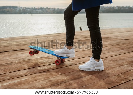 skateboarder skateboarding on the background of frozen lake. copy space.