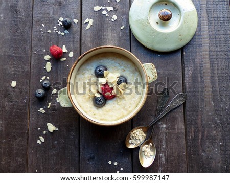 Porridge, berries, selective focus and toned image