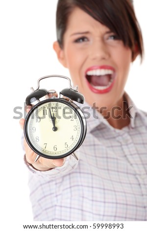 A young business woman with alarm clock isolated