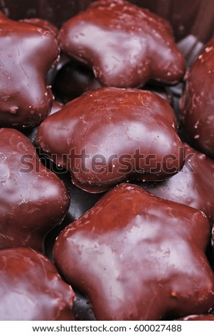 Gingerbread. Chocolate coated gingerbreads as background. Flower shaped gingerbread texture pattern. Cake texture. Cake background

