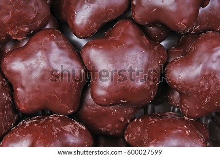 Gingerbread. Chocolate coated gingerbreads as background. Flower shaped gingerbread texture pattern. Cake texture. Cake background
