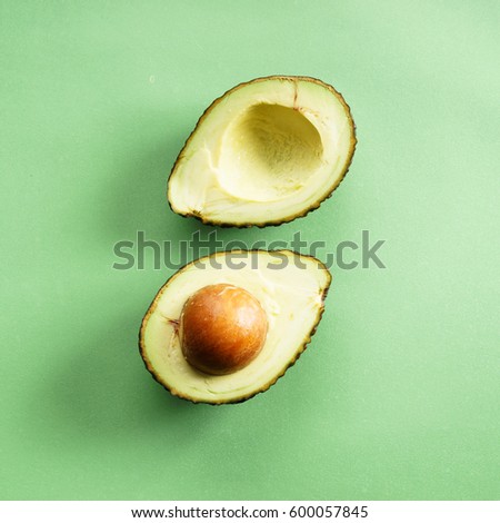avocado on green background,cut half
