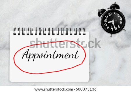 Appointment word annual checkup on white paper memo note. Annual dental check with black table clock on white marble desk office background Business Appointment