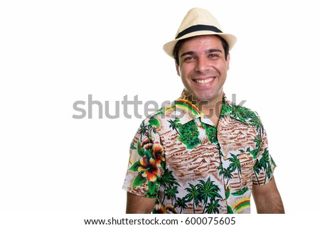 Studio shot of young happy Persian tourist man smiling isolated against white background