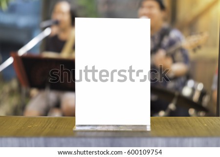 Mock up Menu frame in Bar restaurant ,Stand for booklets with white sheets of paper acrylic tent card on wooden table on