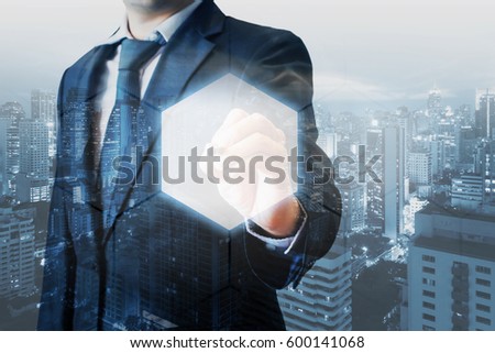 Double exposure of professional businessman touching hexagonal polygon button on a digital interface and city of business background in business and technology choices concept