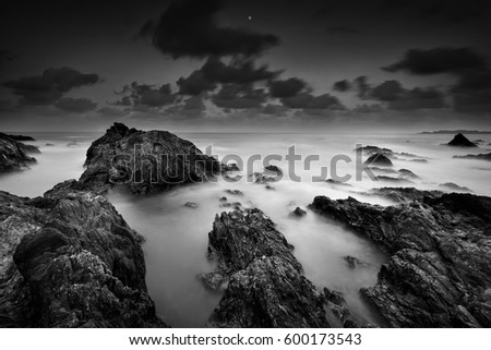 Monsoon came again, seascape rock beach in black and white during storms in Malaysia
