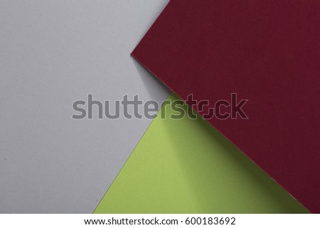 Colored paper background, dark burgundy red, fresh green, soft grey