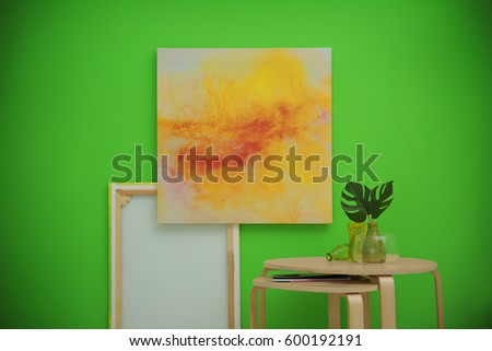 Tables and paintings on greenery wall background