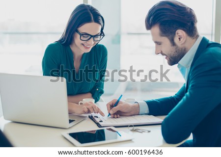 Broker showing to the new owner of a house where he has to sign a contract Royalty-Free Stock Photo #600196436