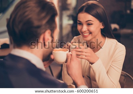 Happy romantic couple sitting in a cafe with coffee Royalty-Free Stock Photo #600200651