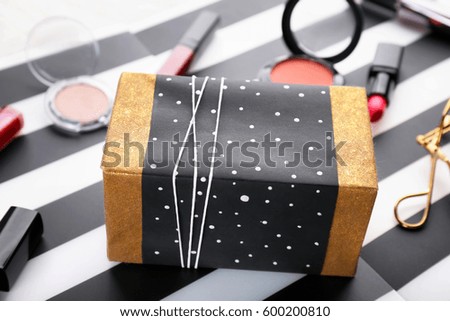 Crafted Christmas gift box on striped background, close up