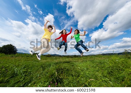 Happy family jumping outdoor