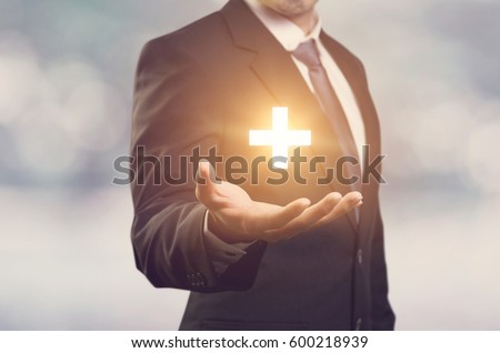Businessman offer positive thing (such as profit, benefits, development, CSR) represented by plus sign. Royalty-Free Stock Photo #600218939