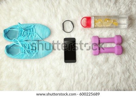 Top view of sport sneakers and equipment on carpet