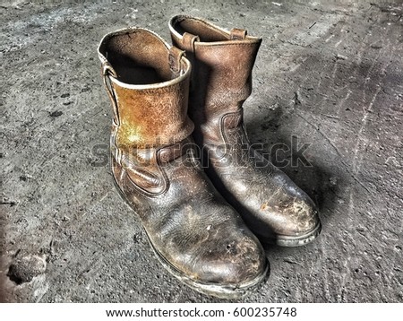 The old style boots cowboy was on dirty cement floor.brown and plenty of dust.used for long life time.