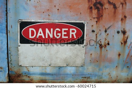 Old grungy warning sign showing danger with room for you text with rust and peeling paint.