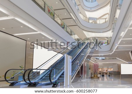 escalator and modern shopping mall interior Royalty-Free Stock Photo #600258077