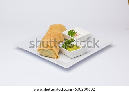 plate with burrito, guacamole and garlic sauce in white background 