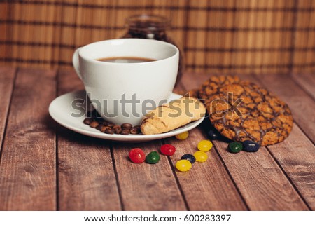 Chocolate biscuits on a wooden background coffee in a mug