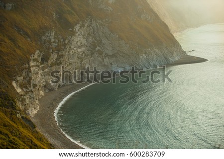  Jurassic coast showing secluded beach, with blue see and white cliffs