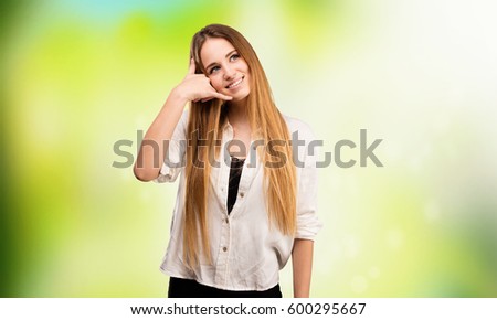 pretty young woman doing calling gesture
