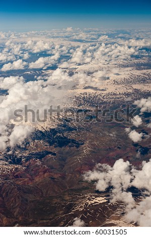 Cloudscape over snowy mountains. Aerophotography.