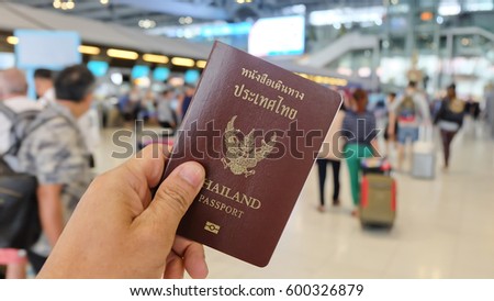 Hand that show the thailand passport at suwannaphum airport. Royalty-Free Stock Photo #600326879