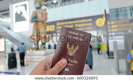 Hand that show the thailand passport at suwannaphum airport. Royalty-Free Stock Photo #600326891