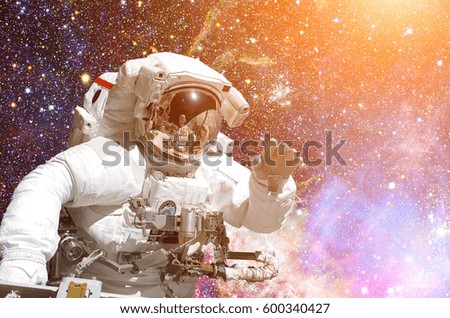 Astronaut in outer space. Galaxy and stars on the background. Elements of this image furnished by NASA.
