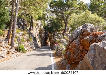 Mountain road road going into a stone tunnel near the village Sa Calobra. Island Majorca, Spain