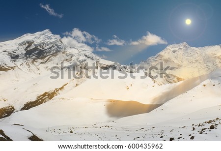 The photo was taken during the trek around the Annapurna mountains in the Himalayas of Nepal. The picture was taken in the morning at sunrise, photographed peak of Mount Annapurna 2.
