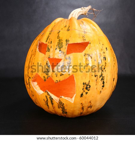 Halloween pumpkin shining on black background
